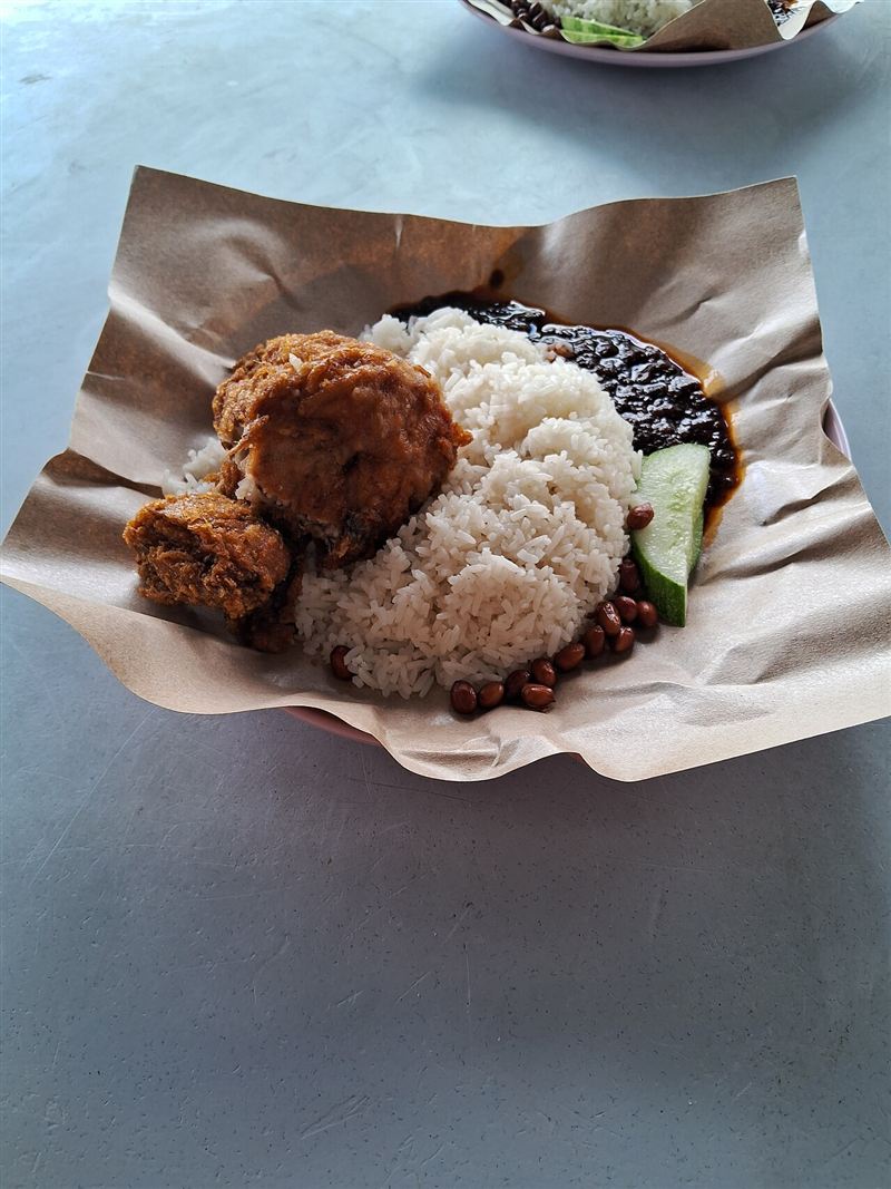 Nasi lemak with fried chicken, sambal, peanuts and cucumber
